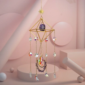Detail of golden sun pendant with purple stone and rainbow crystal prisms decor