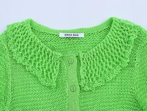 Close-up of neon green crochet knit cardigan with large collar and button details