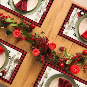 Christmas place mats set featuring red truck and snowflake design on red checkered border
