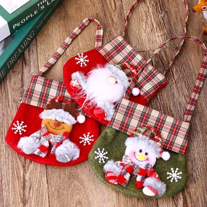 Three Christmas felt candy bags with Santa, Reindeer, and Snowman cartoon designs
