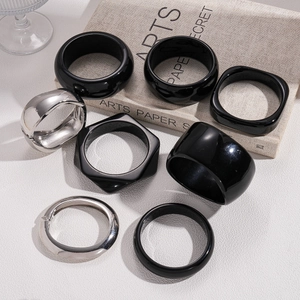 Minimalist black resin and silver metal geometric bangles in round and square shapes