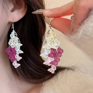 Close-up of elegant gradient butterfly tassel earrings featuring colorful hollow petals
