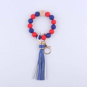 Detail view of colorful silicone beaded keychain with wooden octagon and leather tassel