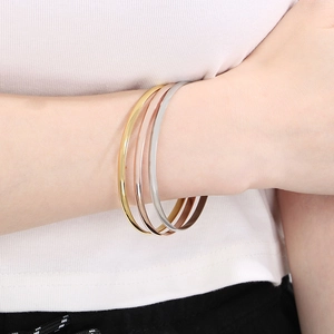 Detailed view of 3.6mm polished stainless steel bangles in gold, rose gold and silver finish