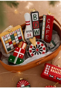 Macro shot of resin Christmas ornaments featuring bingo cards and vintage bus models