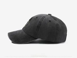 Side view of dark gray washed cotton baseball cap with yellow letter and star embroidery