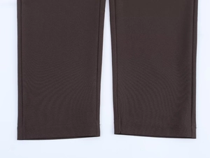 Detail shot of taupe trouser hem showing fine twill texture and precision stitching