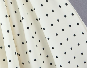 Macro shot of French style polka dot fabric texture with smooth drape and soft finish