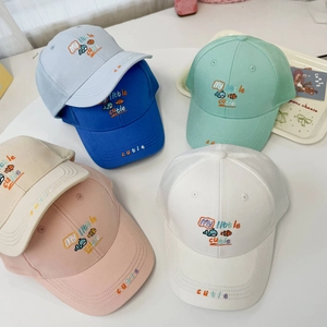 Close-up of mesh summer baseball caps with cartoon whale embroidery in assorted colors