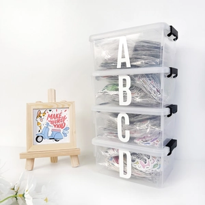 Detail of four-piece stackable transparent storage boxes with black side latches