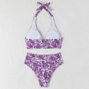 Detail of purple paisley print bikini set showing texture and pattern on white fabric