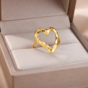 Detail shot of a minimalist 18k gold plated hollow heart ring with lava texture finish