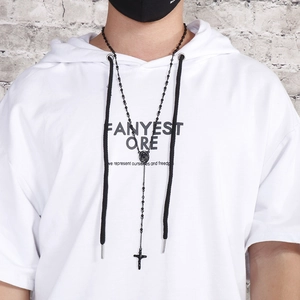 Men's titanium steel cross necklace with rhinestones worn by model against a white brick wall