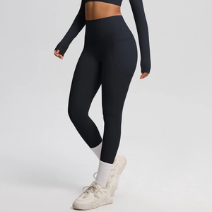 Detail of high-waisted yoga pants with functional side pockets and premium brushed fabric