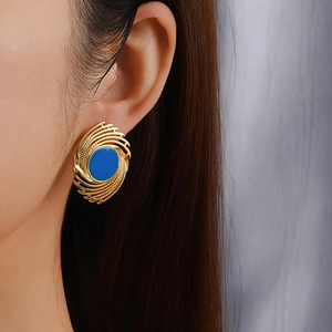 Retro 18K gold-plated oval fireworks earrings with blue inlay on a female model