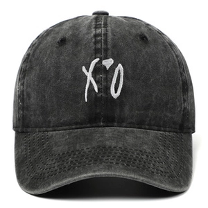 Detailed front view of vintage washed dark gray baseball cap with white XO embroidery