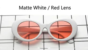 Front view of white oval frame sunglasses with translucent red lenses on checkered surface