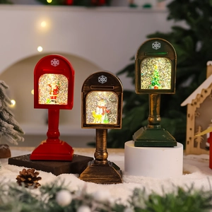 Three decorative Christmas mailbox lanterns with Santa and snowman in warm festive lighting