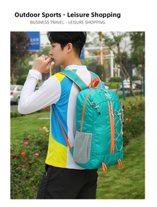 Outdoor hiking backpack in teal with orange zippers shown in use by a male model