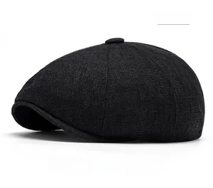Close-up of black cotton linen newsboy cap showing textured fabric and top button