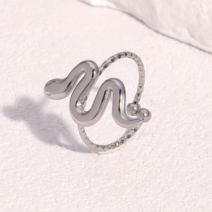 Detail of a polished silver snake-shaped adjustable ring with creative metal textures