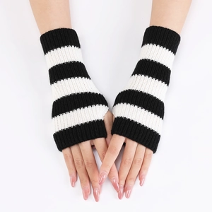 Detail of knitted fingerless gloves with black and white striped pattern and ribbed cuffs
