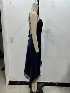 Detail of dark blue satin slip dress featuring eyelash lace hem and side slit design
