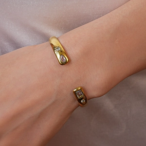 Detail of vintage gold-plated cuff bracelet featuring sunburst drop-shaped zircon inlays