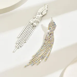 Detailed close-up of long cascade tassel earrings with shimmering crystals in silver finish