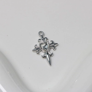 Detailed view of silver cross pendant featuring a heart-shaped crystal center