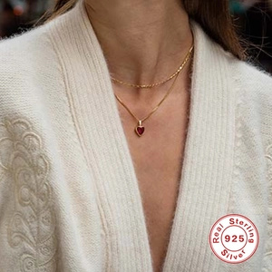 Elegant 925 sterling silver heart-shaped ruby pendant necklace on a gold chain
