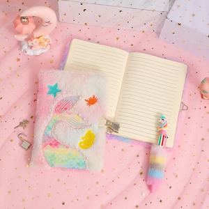 Detail showing the plush mermaid tail diary with a metal lock and matching unicorn pen