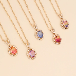 Rose gold sunflower necklaces with multi-colored rhinestone pendants on beige background