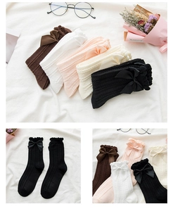 Detailed close-up of colorful knit socks with delicate bows in multiple pastel colors