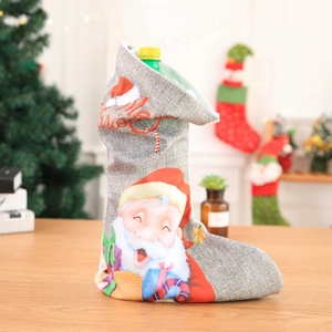Close-up of linen Christmas stocking with Santa Claus motif and Merry Christmas embroidery