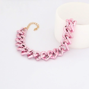 Detail of pink heart-shaped chain pet necklace with adjustable gold extension link