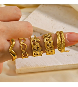 Detailed view of stacked 18K gold plated minimalist geometric heart rings on finger