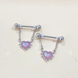 Pink heart opal nipple rings with silver chain and rhinestones on beige background