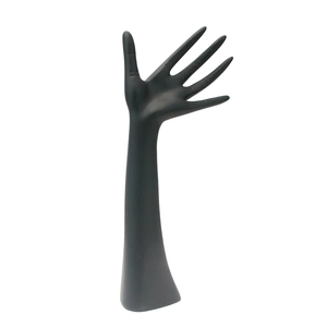 Elegant black matte hand-shaped jewelry stand for displaying rings and bracelets on white backdrop