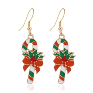 Macro detail of Christmas candy cane earrings with red bow and green holly accents
