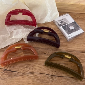 Set of four large trapezoid hair claws in burgundy, purple, orange, and dark green colors