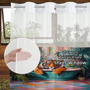 Sheer tiger print curtain showing semi-transparent fabric texture and metal rings