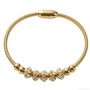 Golden twisted cable bracelet with sparkling white zircons and magnetic clasp
