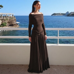 Detail of elegant brown off-the-shoulder pleated maxi dress featuring a high waist design