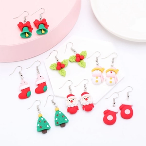 Close-up of colorful resin Christmas earring set with Santa, snowman and tree charms