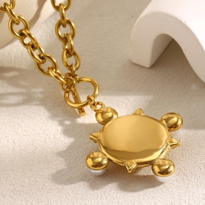 18K gold plated O-link chain necklace with sunburst pendant and toggle clasp on stone