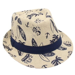 Detailed view of straw fedora with navy summer prints featuring surf and palm motifs