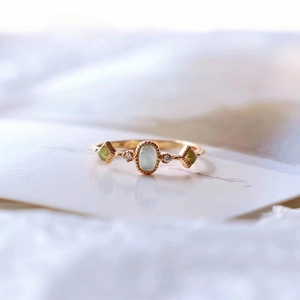 Japanese style open ring with colorful oval green glass gemstones in gold setting