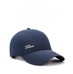 Detail of dark blue baseball cap showing laser-cut ventilation holes and side embroidery