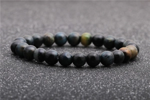 Macro shot of colorful tiger eye stone beads with polished finish and natural cat-eye luster